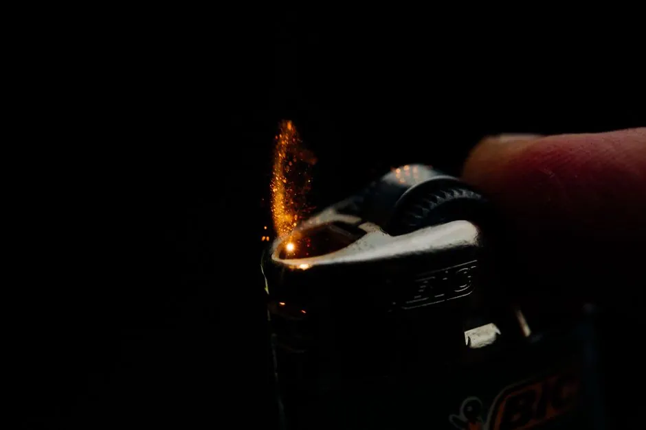 Close-up of a Bic lighter igniting with sparks against a dark background. Captures the essence of fire and ignition.